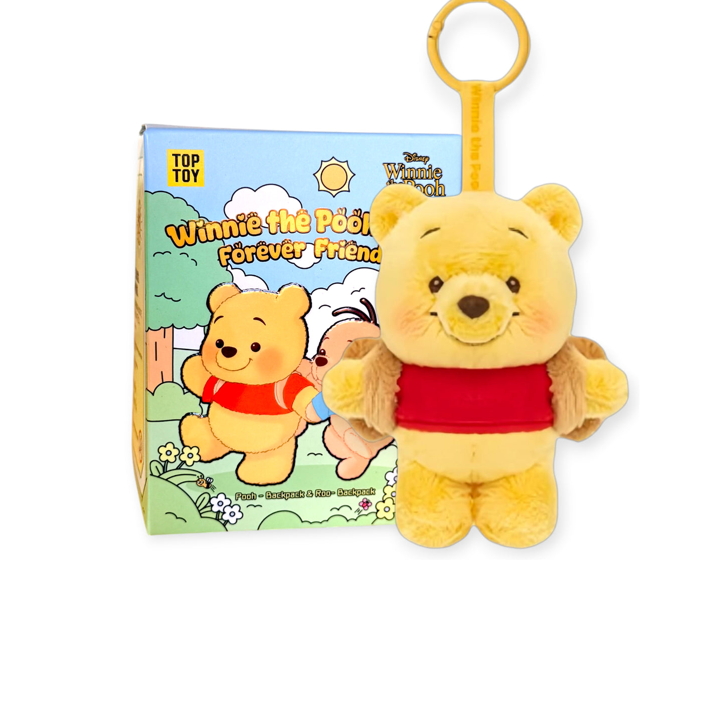 Plush Winnie the Pooh keychain with red shirt hanging in front of colorful Forever Friends packaging box