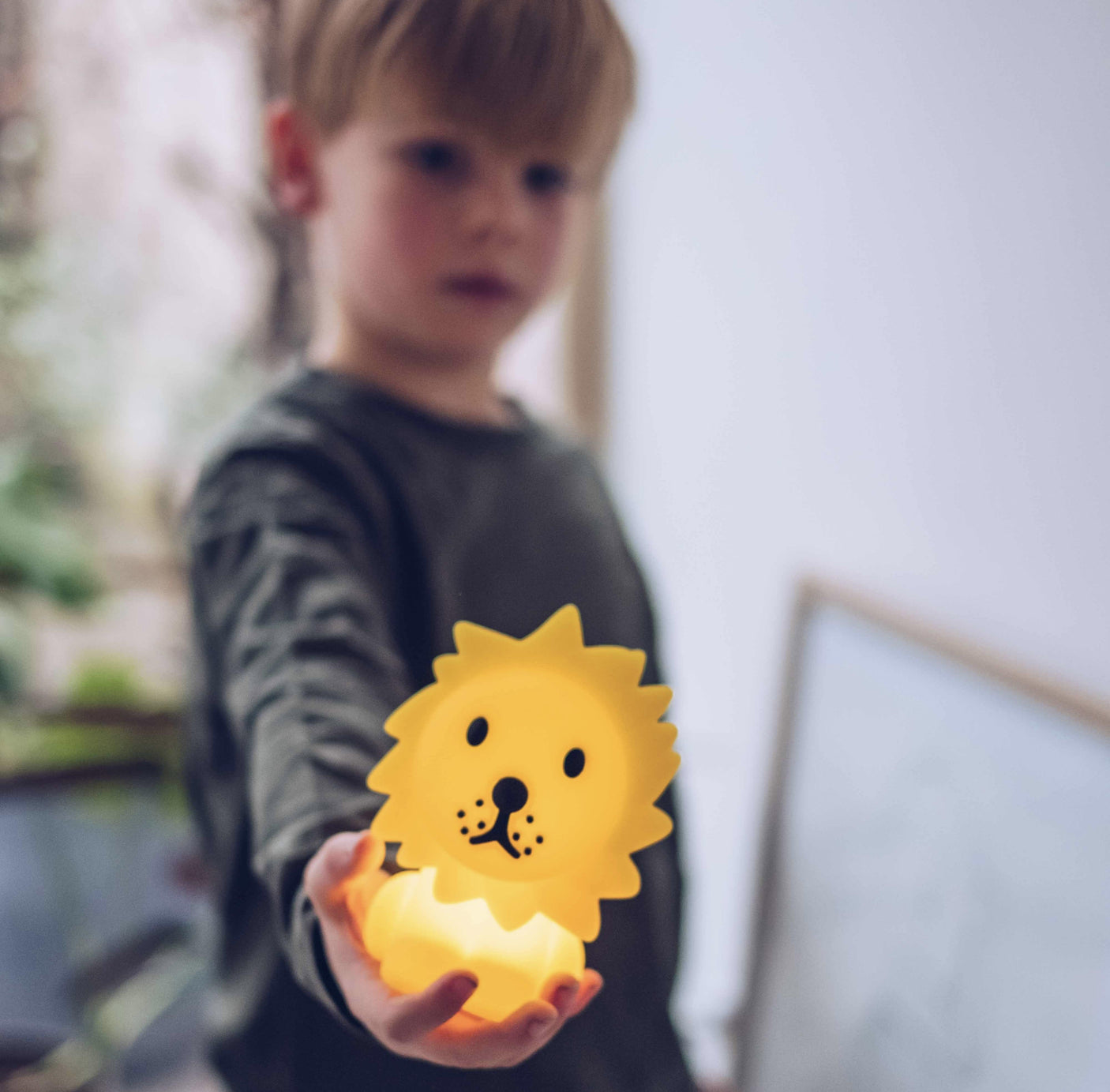 Child holding the Lion Miffy Night Light (15cm) from the Miffy brand, with a blurred background.