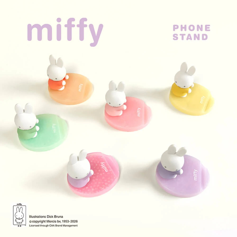 Assorted pastel bunny phone stands with white figurines on orange, pink, green, and purple bases