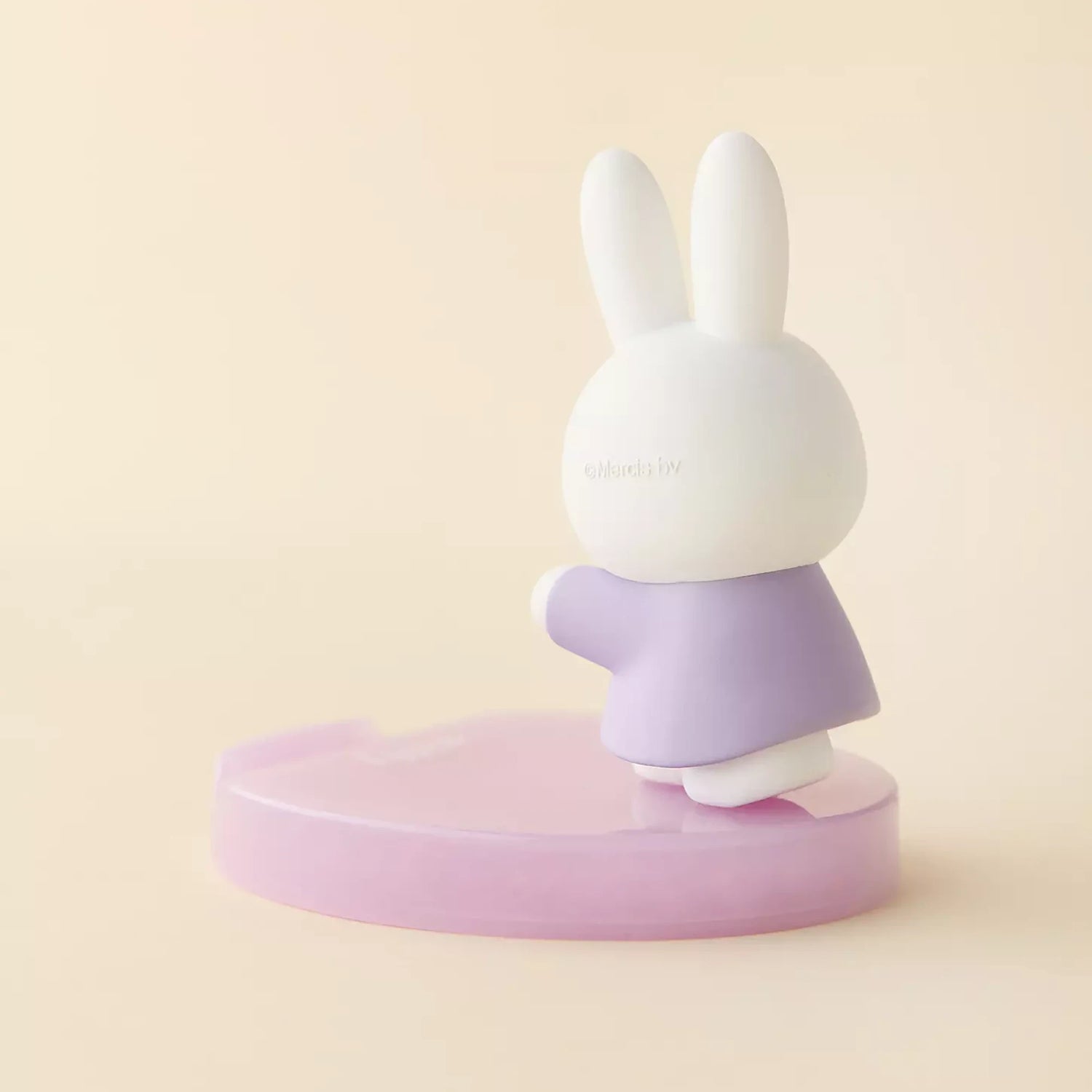 Rabbit phone stand figurine with white head and purple skirt on round base