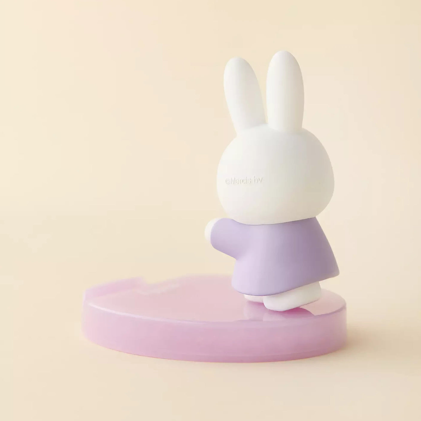 Rabbit phone stand figurine with white head and purple skirt on round base