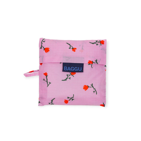 Folded Standard Baggu Bag in Painted Wildflower pattern with small red flowers on light pink background, gallery position 1