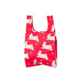 Red reusable bag patterned with white rabbits and small yellow flowers on a plain white background