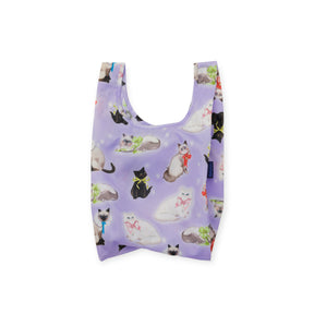 Folded Baby Baggu bag in pastel purple featuring various illustrated cats with colorful ribbon bows and navy blue label