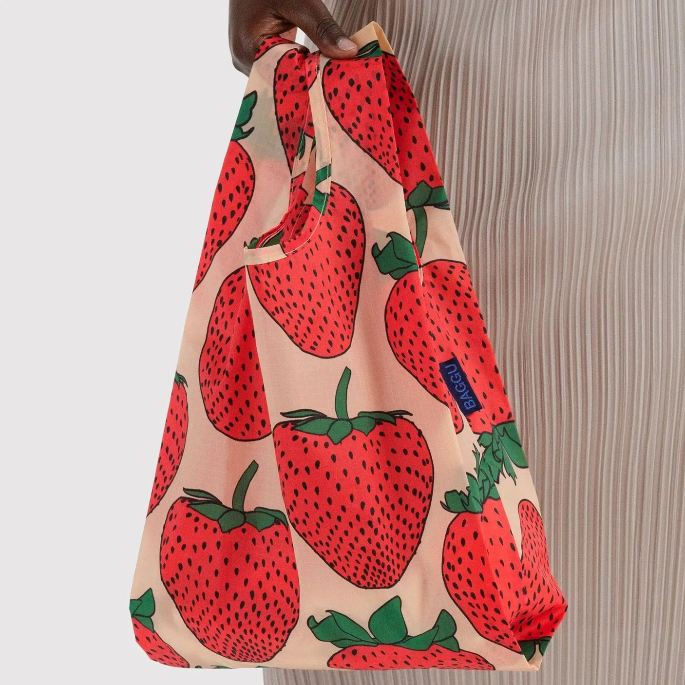 Baby Baggu bag with strawberry print, tote held by top handle