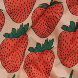 The Baby Baggu Reusable Bag - Strawberry by Baggu features a charming fabric design with large red strawberries and green leaves set against a light beige background, making it ideal for crafting reusable bags.