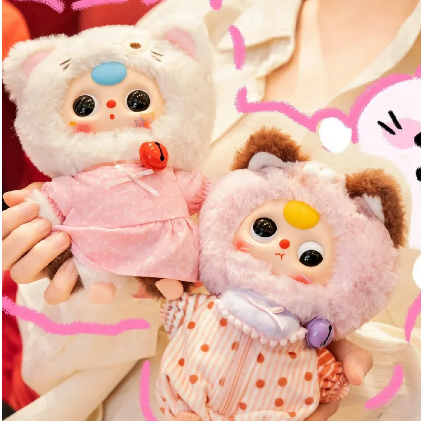 Two plush animal keychains: pink cat in light dress and orange-brown bunny with key ring