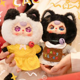 Two plush animal keychains with colorful eyes: yellow dress cat and white shirt bear; rings