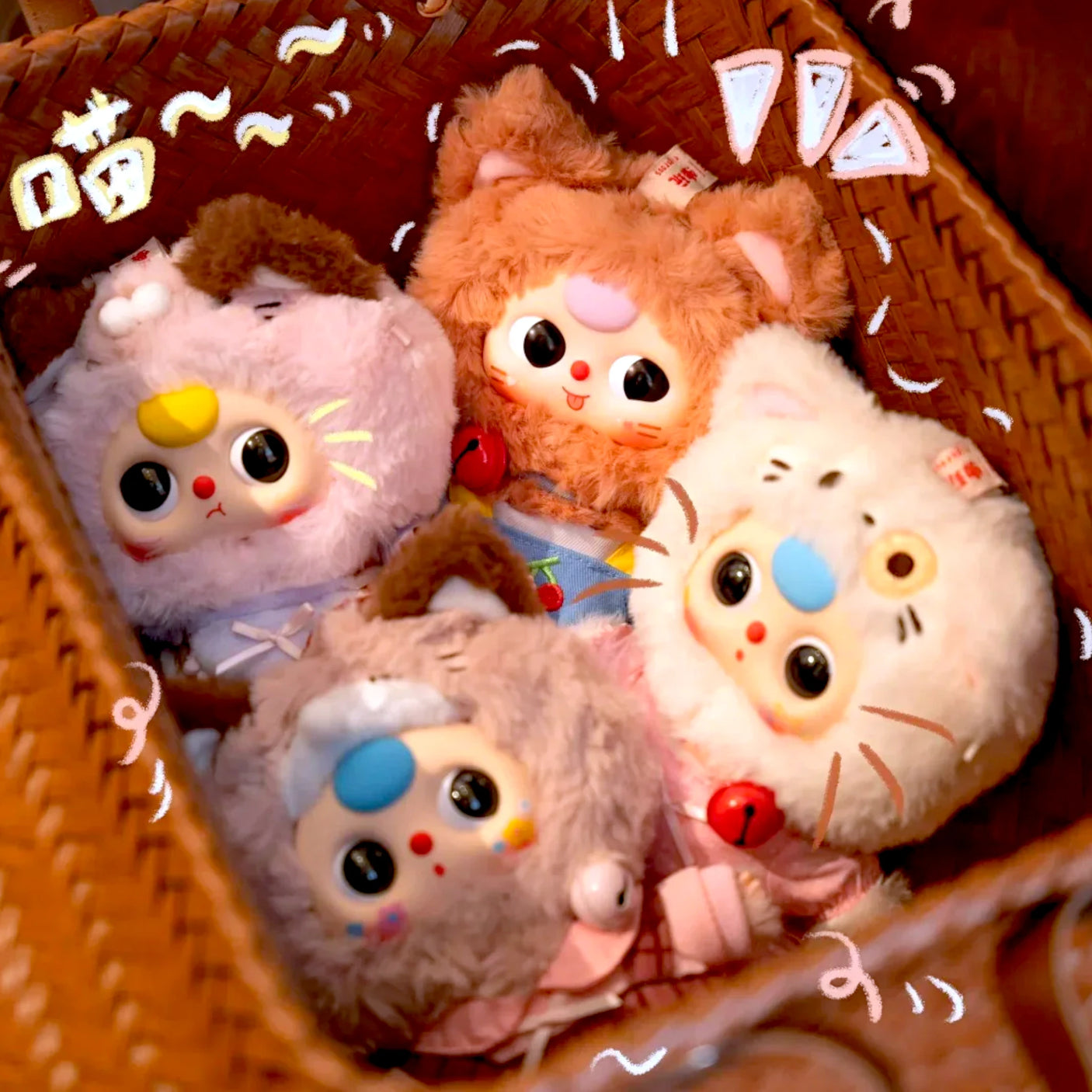 Plush kitten keychain blind box figures in a brown woven basket, assorted colors
