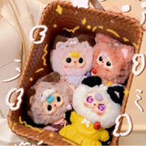 Plush kitten keychain blind box figures arranged in a brown woven basket
