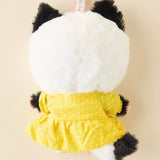 Cat keychain plush with white furry back and yellow dotted dress; black paws and key ring