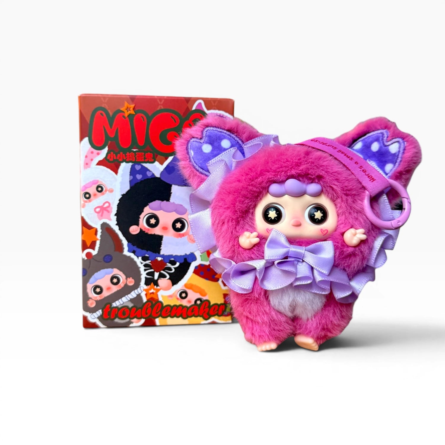 Pink furry plush character pendant with bow and star-eyed face