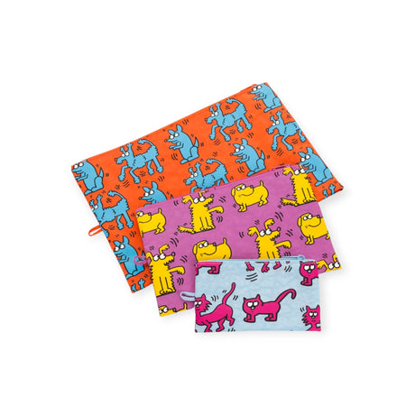 Explore the Baggu Go Pouch Set - Keith Haring edition, showcasing three lively designs crafted from recycled materials. These pouches feature playful cartoon animals—blue dogs on orange, yellow cats on purple, and pink cats on blue—reflecting a burst of creativity inspired by Keith Haring.