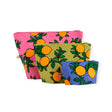 The Baggu Go Pouch Set - Orange Trees by Baggu includes three zippered pouches of different sizes, each decorated with vibrant orange fruit patterns set against pink, green, and blue backgrounds. Made from recycled materials, these stylish and sustainable pouches combine fashion with eco-friendliness.