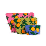 The Baggu Go Pouch Set - Orange Trees by Baggu includes three zippered pouches of different sizes, each decorated with vibrant orange fruit patterns set against pink, green, and blue backgrounds. Made from recycled materials, these stylish and sustainable pouches combine fashion with eco-friendliness.