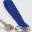 The Baggu Logo Keychain - Peony, crafted from recycled nylon webbing with "BAGGU" text, is shown on a white background attached to two silver keys.