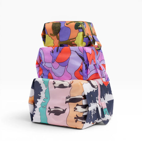 Baggu travel storage set with three zip pouches, colorful animal-print fabric