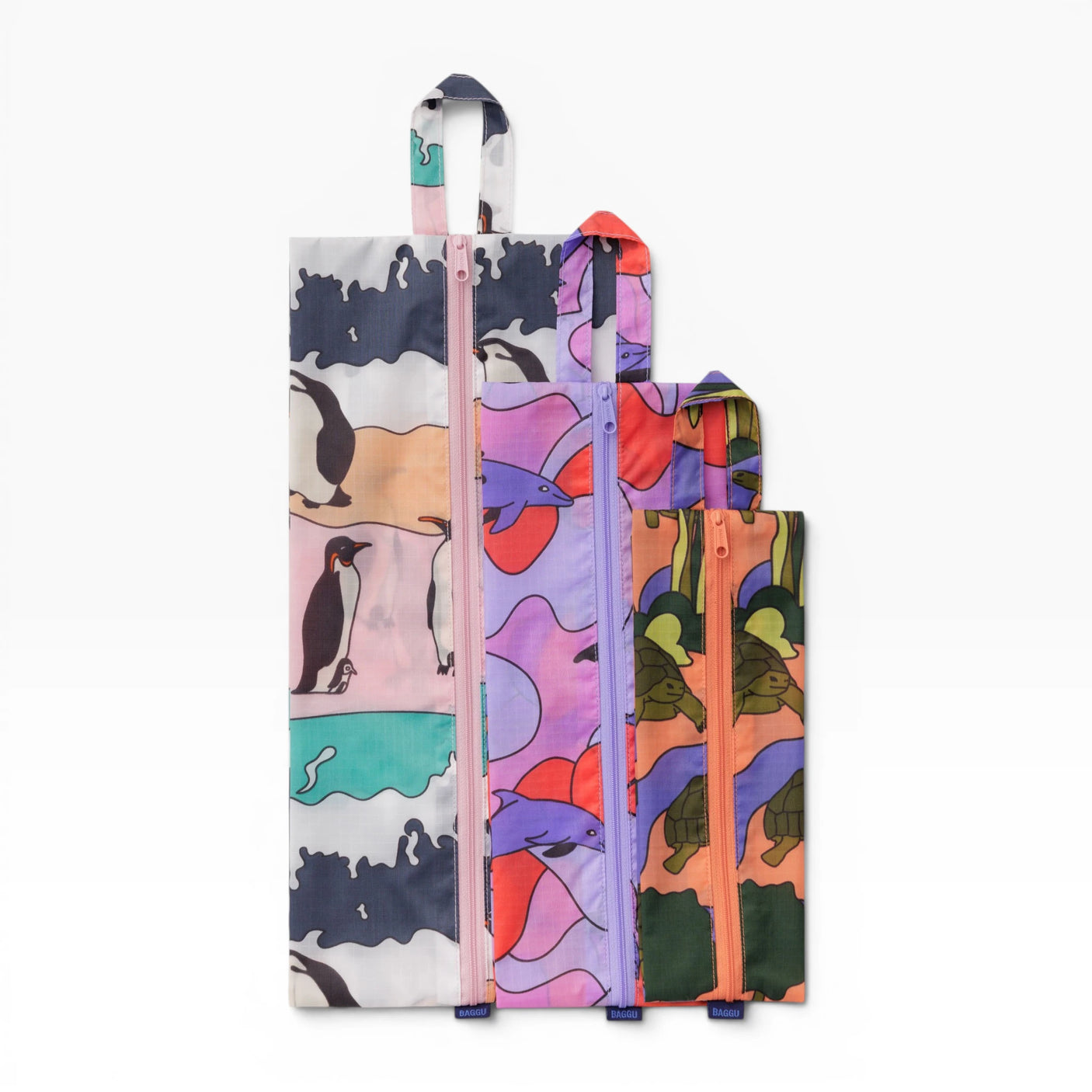Travel storage set with three upright zip pouches in colorful animal print fabric