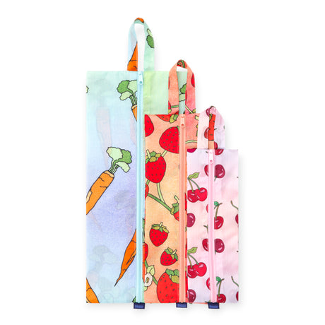 Set of three reusable fabric bags with carrot, strawberry, and cherry prints, each featuring a zipper and carrying loop