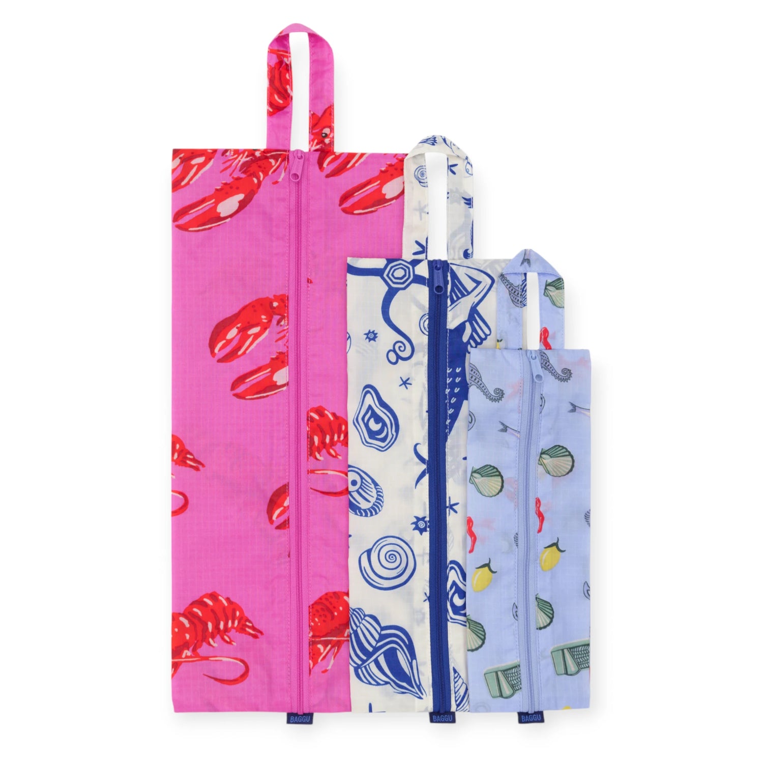 The Baggu Storage & Travel Set - Sea Creatures includes three reusable zippered pouches in different sizes, each with a handle and colorful sea creature patterns—ideal for storing essentials or organizing while traveling.
