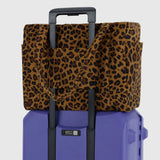 Baggu leopard print cover over purple hard shell with pull handle