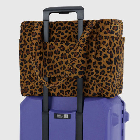Baggu leopard print cover over purple hard shell with pull handle
