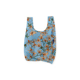 The Baby Baggu Reusable Bag - Orchid by Baggu is crafted from 100% recycled nylon and showcases a stunning combination of orange flowers and green leaves, making it an elegant addition to your shopping routine.