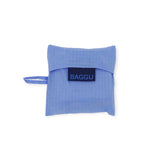 The Baby Baggu Reusable Bag in Cornflower, crafted by Baggu, folds into a compact square with a handle and is made from recycled nylon.