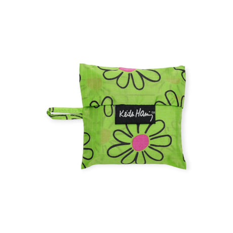 Green pouch featuring a bold Keith Haring flower print, complete with a small handle. It proudly sports a "Kido Hairs" label on the front, highlighting its commitment to sustainable fashion. A perfect fusion of practicality and style akin to a Baby Baggu Keith Haring - Flower from Baggu.