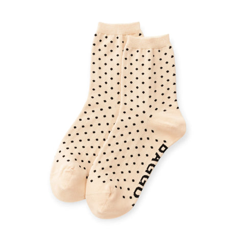 Pair of cream crew socks with black micro polka dots and Baggu logo text