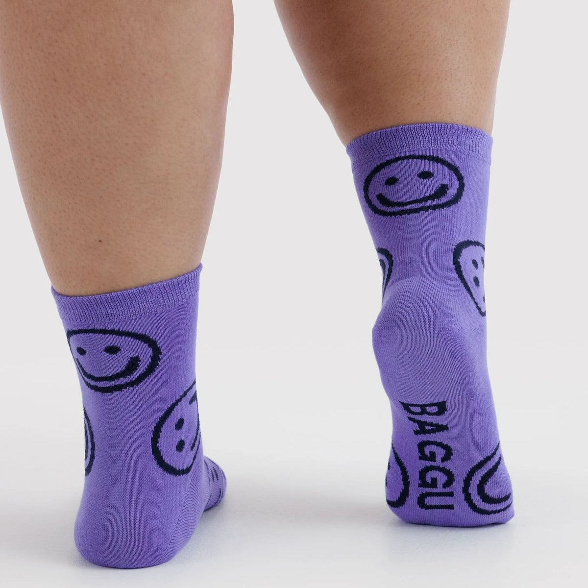 Baggu lavender crew socks with smiling face and 'Baggu' text on cuff.