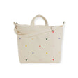 The Baggu Duck Bag Medium in cream by Baggu showcases an adjustable strap and delightful embroidered heart patterns.