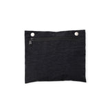 Small black fabric pouch with zipper closure and two silver snap buttons on top edge isolated on white background
