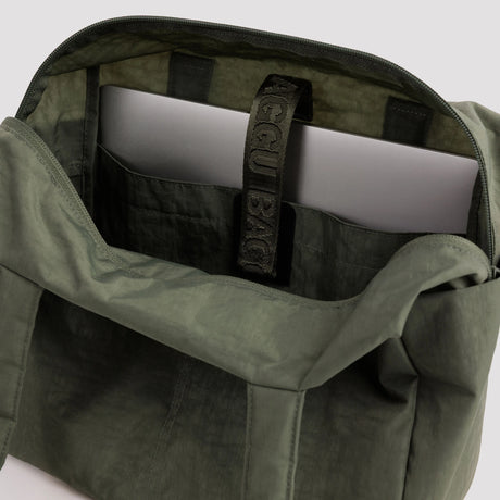 Olive green bag interior with zip pocket and label webbing strap