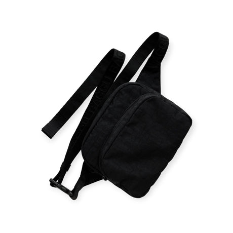 The Baggu Fanny Pack in black, designed by Baggu, is made from recycled nylon and includes two zippered compartments along with an adjustable strap. It is displayed on a white background.