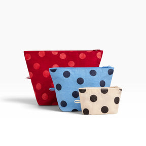 Baggu Go pouch set of three polka dot pouches: red, blue, and beige with black dots.