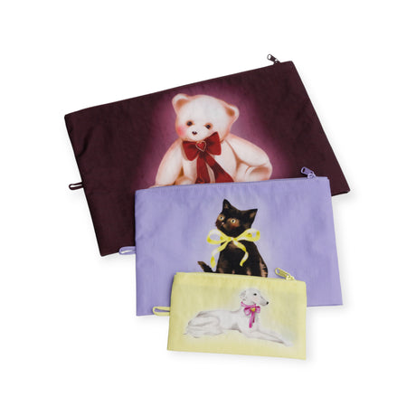 Keep essentials organized with the Baggu Go Pouch Set - Fancy Animals by Baggu, featuring three different-sized pouches decorated with a bear, black cat, and white dog sporting colorful bows.