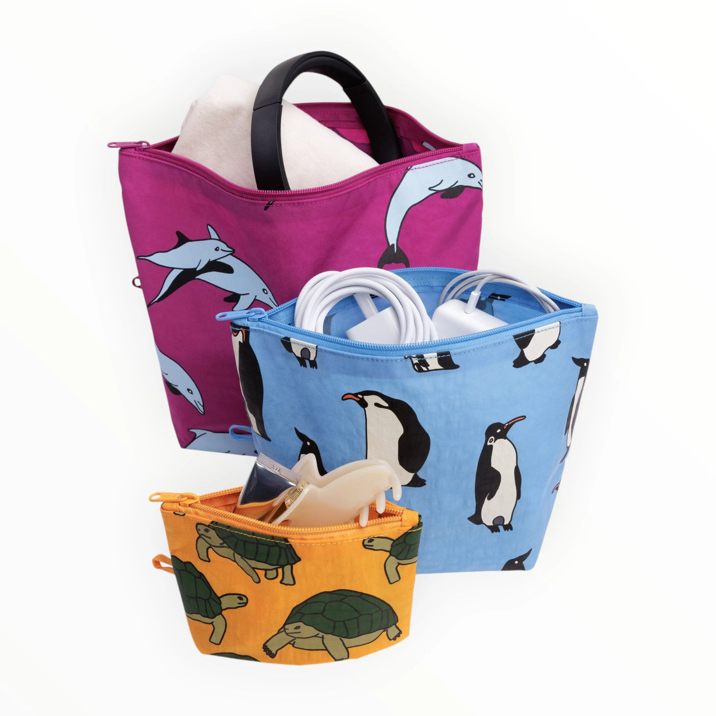 Stacked pouches with penguin and dolphin prints; magenta, blue, orange zip pouches