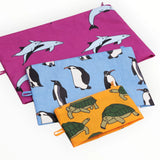 Set of fabric pouches with dolphin and penguin prints; magenta, blue, orange zip