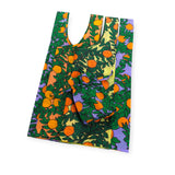 The Baggu Set of 3 Standard Bags - Orange Trees offers an eco-friendly option with a vibrant pattern of orange and leaves on a purple background, made from recycled nylon and designed for easy folding.