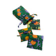 The Baggu Set of 3 Standard Bags - Orange Trees, featuring a vibrant citrus fruit pattern, are on display. Made from eco-friendly recycled nylon, three bags are folded neatly while one larger bag is open in the background.