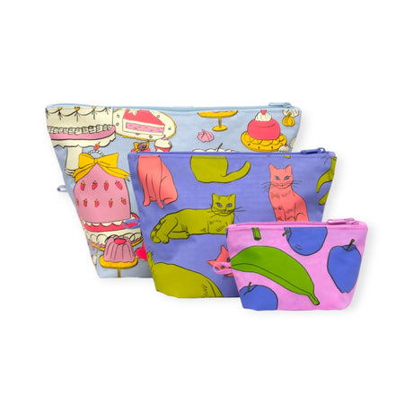 The Baggu Go Pouch Set - Still Life by Baggu includes four vibrant zippered pouches in assorted sizes with charming prints of desserts, cats, and fruit. Crafted from eco-friendly recycled nylon, they offer a playful touch while remaining environmentally conscious.