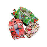 The Hello Kitty x Baggu Storage & Travel Set from Baggu includes three vibrant zippered bags, each adorned with playful cartoon designs. These bags, made from sustainable materials, are open and holding various items such as clothes and shoes, making them ideal for storage and travel.