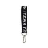 Baggu Keychain - Logo Strap, a black strap made from recycled nylon webbing, showcasing the word "BAGGU" in white letters, and equipped with a metal carabiner clip.