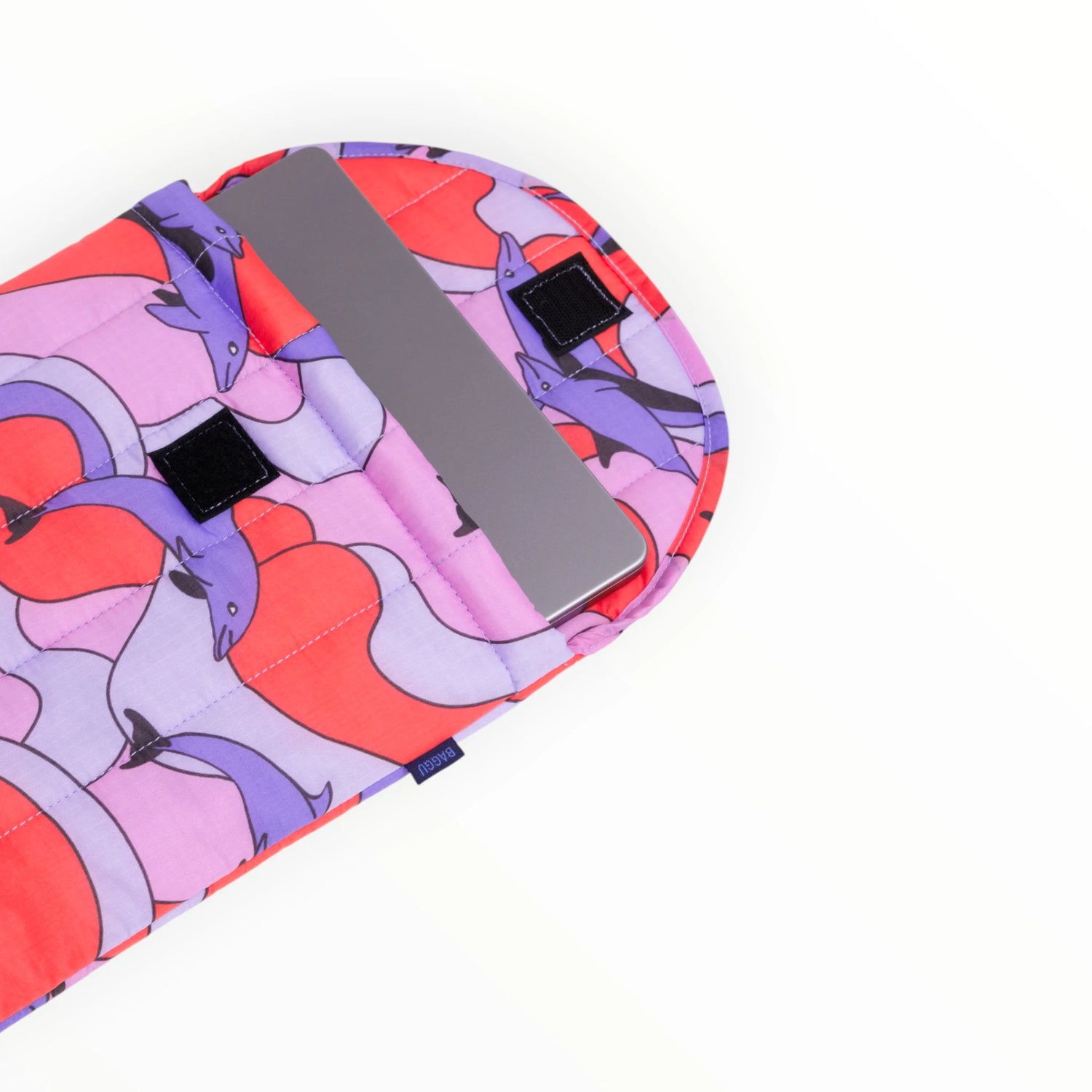 Puffy laptop case open view with dolphin print exterior and black strap detailing