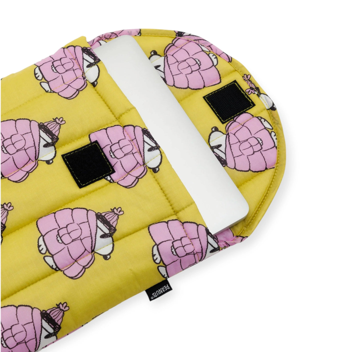 A Snoopy Puffer 13"/14" Laptop Sleeve from the Peanuts x Baggu collection in yellow, featuring a pink bear pattern, is partially open to reveal a white tablet inside.