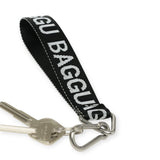 Black Baggu logo keychain with fabric strap and metal key ring clip