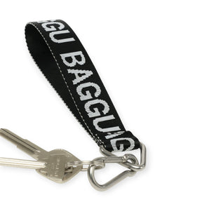 Black Baggu logo keychain with fabric strap and metal key ring clip
