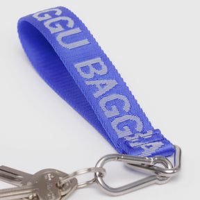 Close-up of royal blue Baggu Logo keychain strap with silver keyring and clip, gallery image 1, baggu_logo-keychain_royal-blue_02.webp