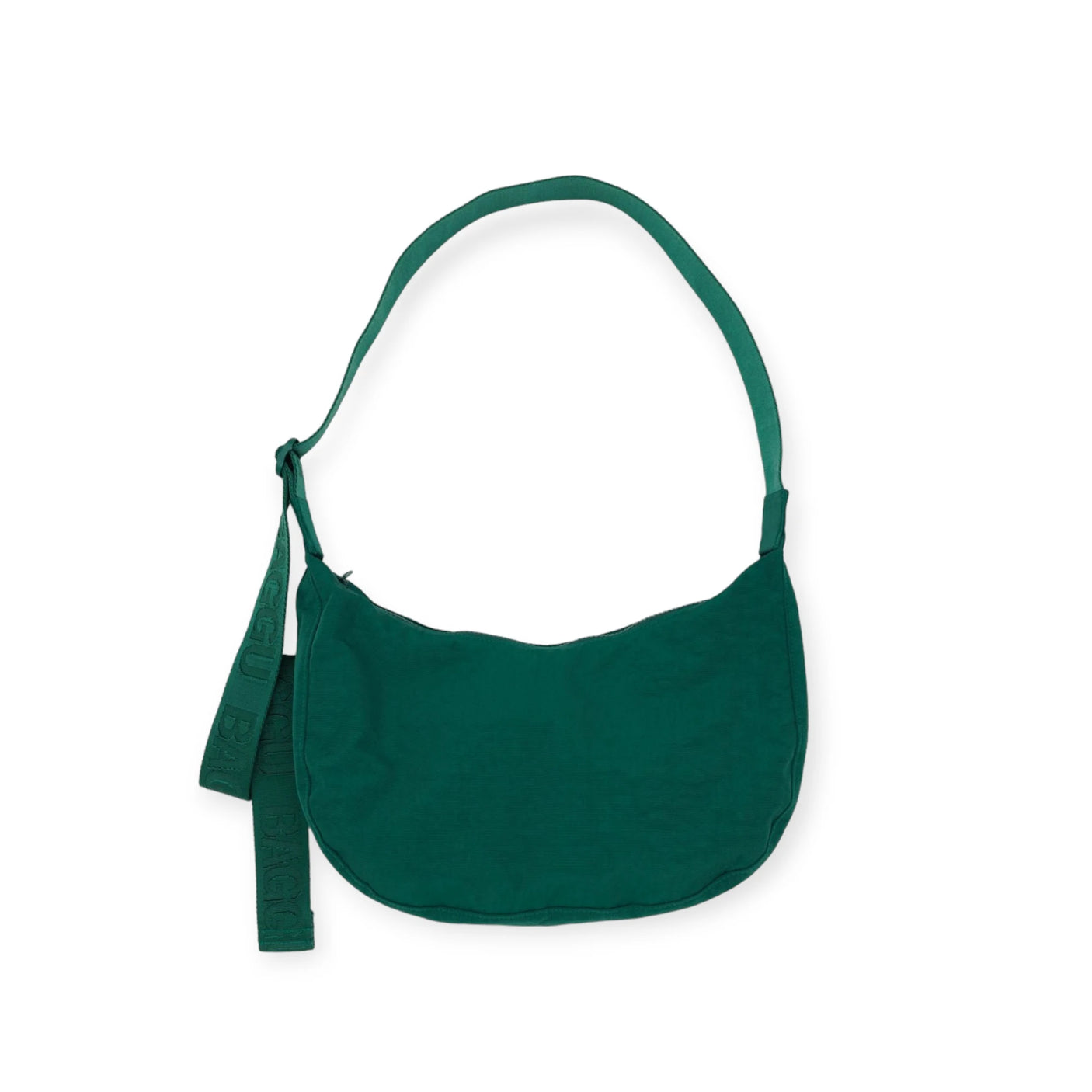 The Baggu Medium Nylon Crescent Bag - Cypress includes an adjustable tonal logo strap and a delightful decorative ribbon on the handle.